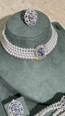 Close-up of bridal pearl choker with sparkling crystal centerpiece