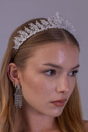 Silver zircon bridal crown worn by a bride, featuring a tall central peak and detailed fern leaves for a regal wedding look