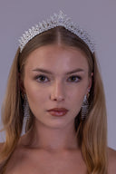 Angled view of a silver wedding tiara featuring clear zircon leaves and a prominent center peak on a bride.