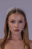 Left angled view of a silver bridal tiara featuring teardrop zircon stones and delicate leaf branches.