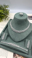 Complete luxury bridal jewelry set with a pearl statement necklace, matching floral earrings, bracelet and adjustable ring