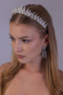 Side view of a botanical zircon bridal crown highlighting layered flower clusters, upright leaves and a slim silver tiara base.