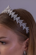Side view of a silver bridal crown featuring marquise zircon leaf clusters arranged along an elegant botanical tiara band.