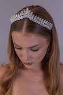 Top front view of a luxury wedding crown featuring a central teardrop zircon surrounded by sparkling leaf details.