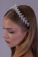 Close-up of a luxury leaf wedding headpiece, highlighting sparkling marquise zircon branches in a detailed silver setting.