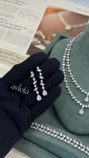 Pair of long bridal earrings with alternating marquise and round zircon stones and pear cut drops