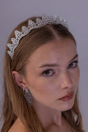 Elegant zircon bridal crown framing the bride’s hairstyle with sparkling leaf clusters and a refined silver finish.