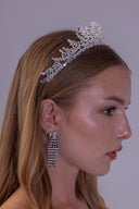 Side profile of a bride wearing a nature-inspired silver-plated tiara with delicate foliage details