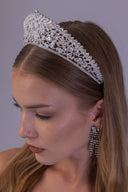 Teardrop zircon wedding crown shown at an angle, with detailed floral vines and an elevated royal silhouette for brides.