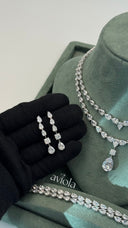Pair of bridal drop earrings with graduated pear cut stones princess accents and teardrop ends