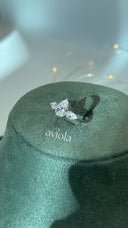 Adjustable rhodium plated bridal ring with a large pear cut center and two pear cut side stones