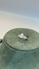 Adjustable bridal ring with a large pear cut zircon center and princess cut side stones