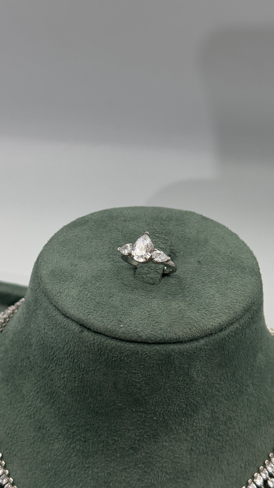 Adjustable bridal ring with a large pear cut center stone and two matching pear cut side stones