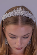 White pearl wedding tiara shown at an angle, with delicate floral branches and clear faceted beads for a romantic bridal look.