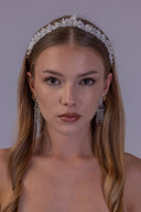 Silver leaf bridal tiara shown in profile, highlighting evenly spaced white pearls and a refined wedding crown silhouette.