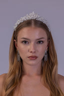 Beaded floral bridal crown shown from the opposite angle, highlighting pearl accents and a softly elevated center for brides.