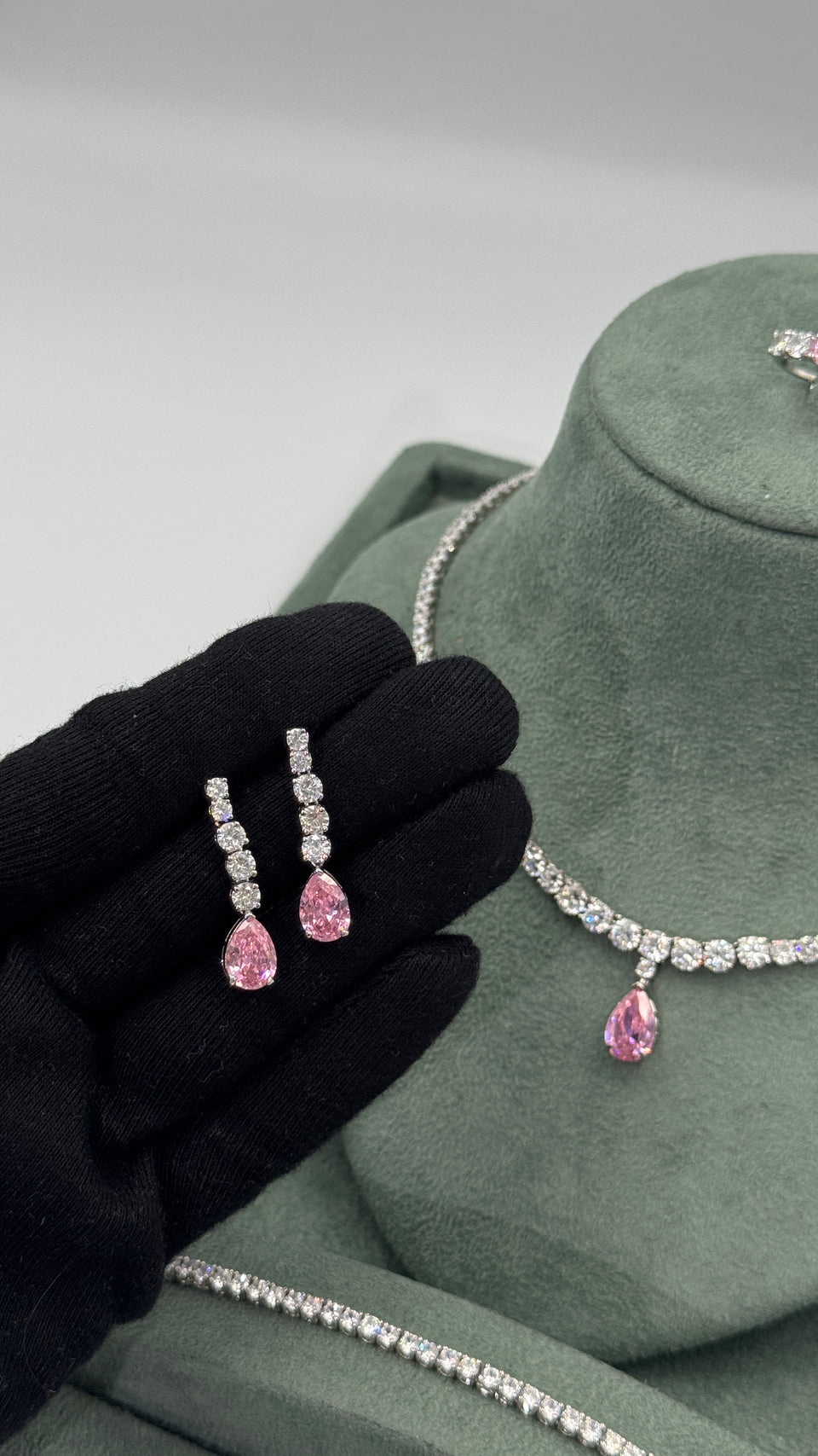 Pair of pink pear cut zircon bridal earrings with four graduated clear round stones