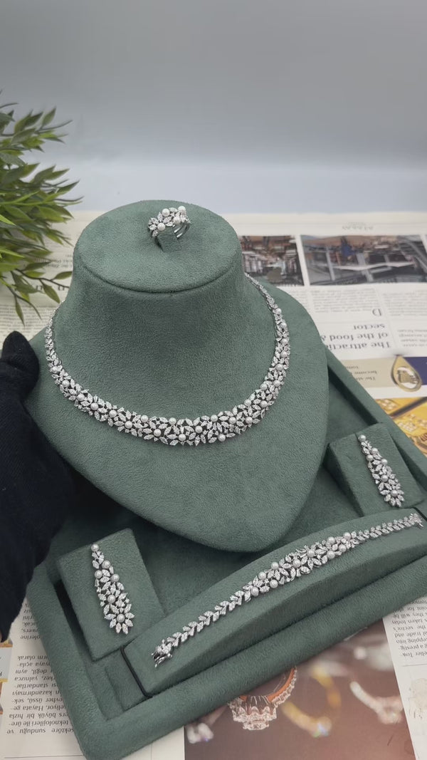 Elowen luxury bridal wedding jewelry set video showing the pearl statement necklace, floral earrings, matching bracelet and adjustable ring.