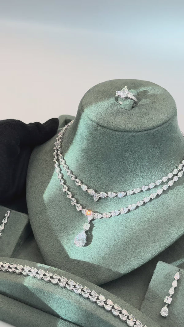 Seraya bridal jewelry set video showing the double layer pear cut tennis necklace earrings bracelet and adjustable ring