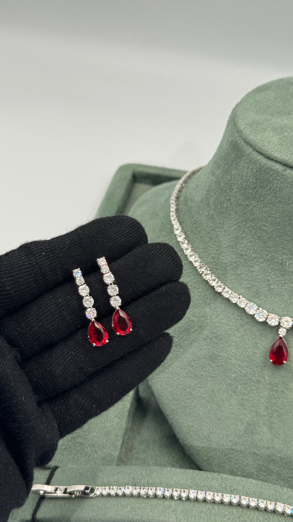 Pair of red pear cut zircon bridal earrings with four graduated clear round stones