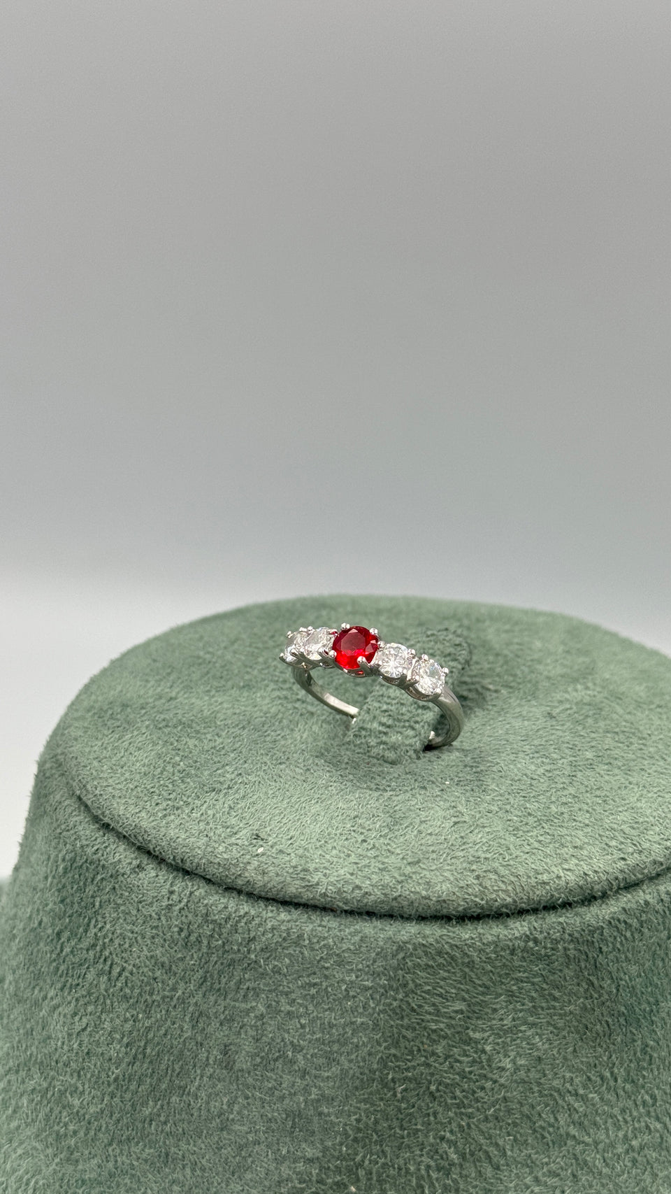 Adjustable five stone bridal ring with a red round zircon center and four clear side stones