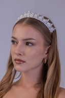 Bride wearing a romantic silver crown with layered AAAA zircon leaves and evenly distributed white pearl embellishments.