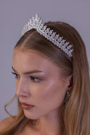 Side profile of a bride wearing a zircon bridal crown with detailed botanical branches and a silver-tone finish.