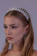 Luxury zircon princess crown worn by a bride, showing its openwork spire pattern and elevated silver wedding headpiece profile.