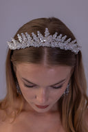 Luxury floral wedding crown shown at an angle, highlighting its graduated zircon branches and statement bridal silhouette
