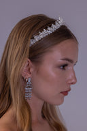 Front close-up of a romantic pearl wedding crown with symmetrical leaf details and a delicate elevated center for brides.