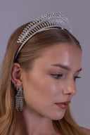Close-up of a zircon bridal crown showing sparkling vertical rows, oval stone accents and a silver double-band base