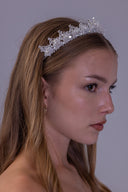 Side profile of a snowflake-inspired bridal tiara featuring sparkling zircon sprays, pearl accents and an elegant raised silhouette.