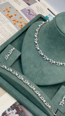 Close up of pearl bridal necklace with delicate leaf design stones