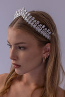 Front view of a statement zircon wedding crown with graduated teardrop accents, designed to frame the bride with royal elegance.