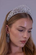 A woman wearing a sparkling silver tiara with clear rhinestones