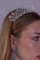 Right side profile of a bride wearing a luxury silver branch tiara with sparkling zircon leaves and teardrop details.