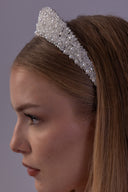 Front close-up of a pearl wedding tiara with clear faceted bead clusters, designed as a romantic statement headpiece for brides