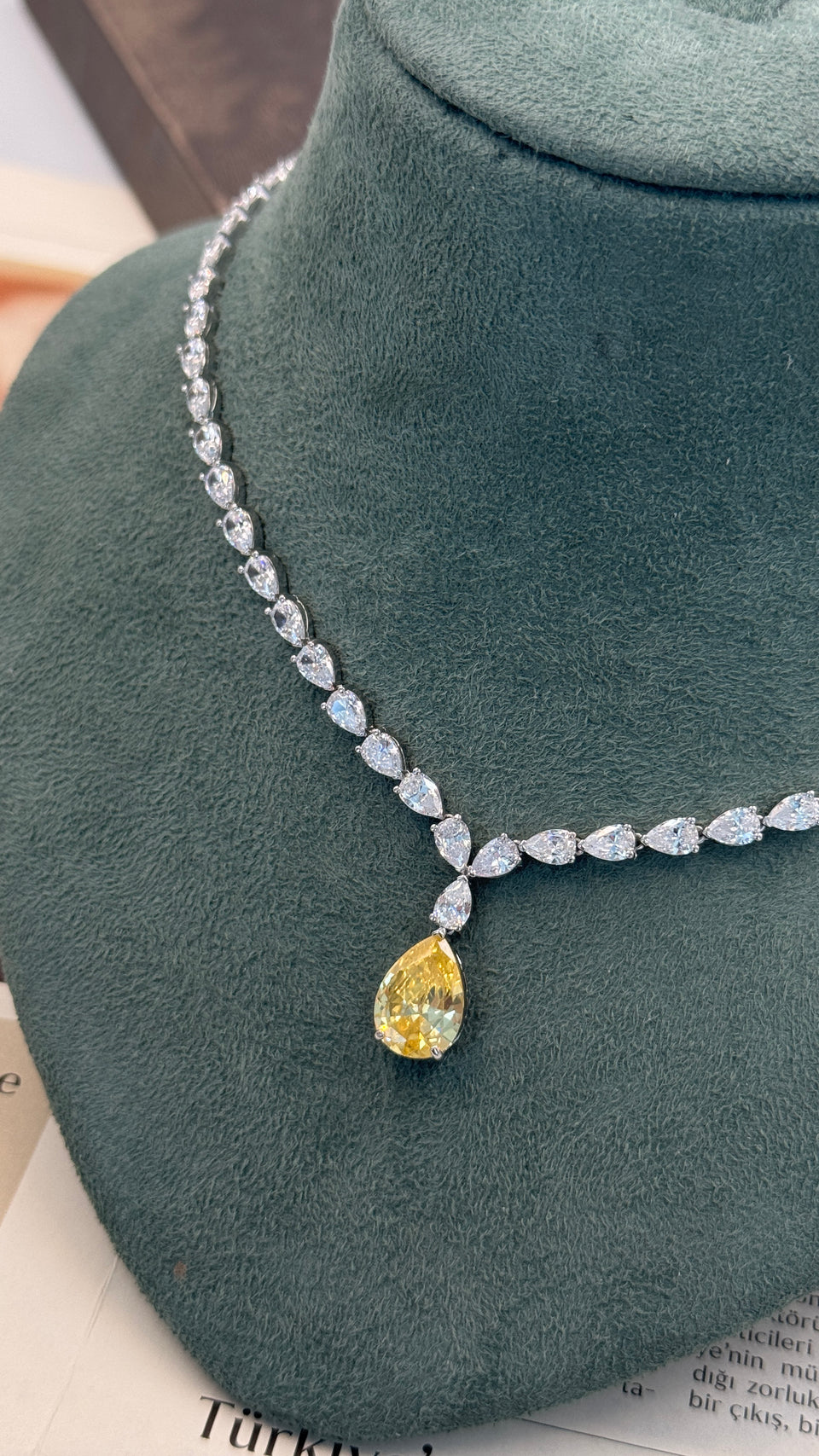 Bridal yellow crystal jewelry set on green stand elegant luxury display