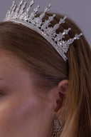 bride wearing a royal silver zircon wedding crown with graduated spires designed to create an elegant regal presence.