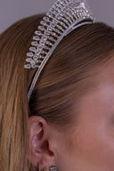 Front view of a statement bridal crown with graduated silver zircon rays and a balanced royal wedding tiara shape